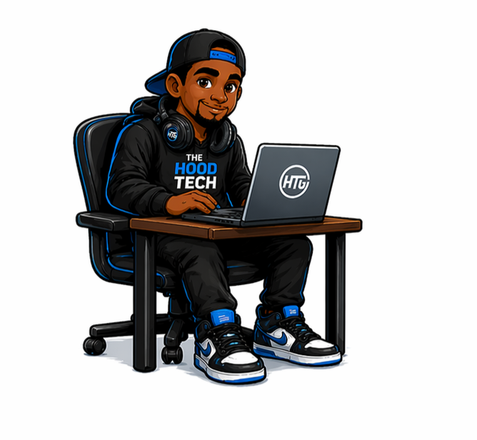 The Hood Tech Guy sitting at a desk with laptop